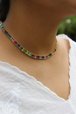 Multicolored Jeweltone Parade Necklace on a model's neck with a blurred background