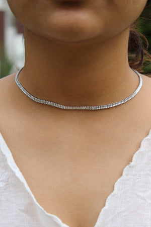 Close-up of a Twilite Necklace on a model's wearing a white top
