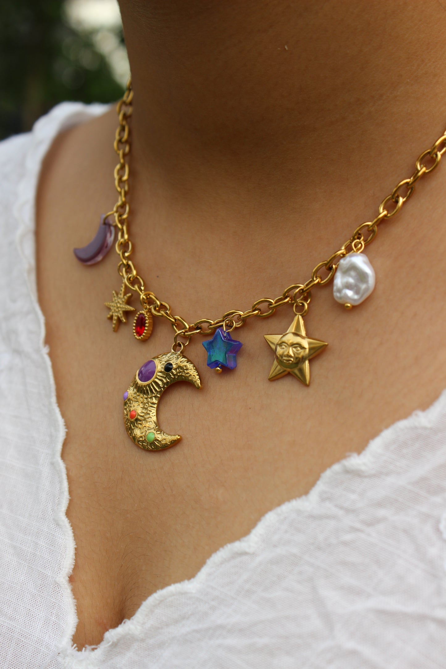 Lunar Spells Charms Necklace on a model's neck against a white background
