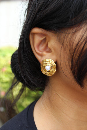 Close-up of a model wearing a Amara Stud Earrings with a pearl center