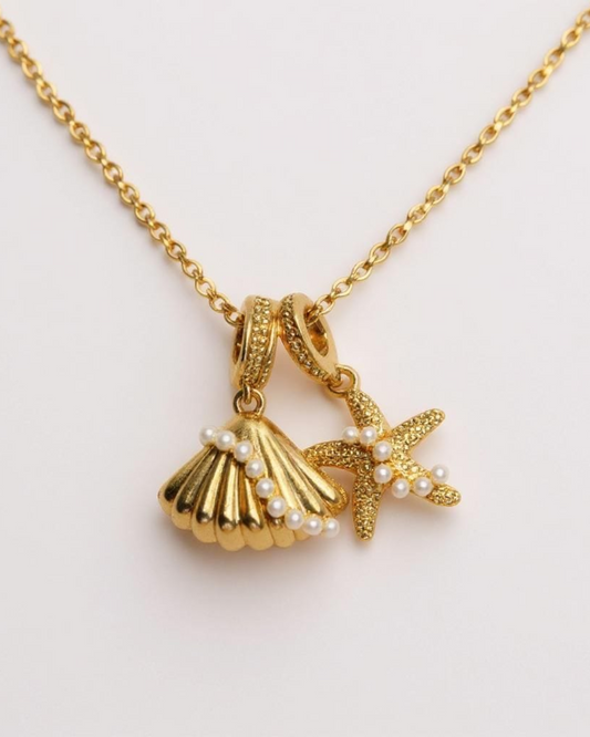 Shore Whispers Charm Necklace on a light pink background