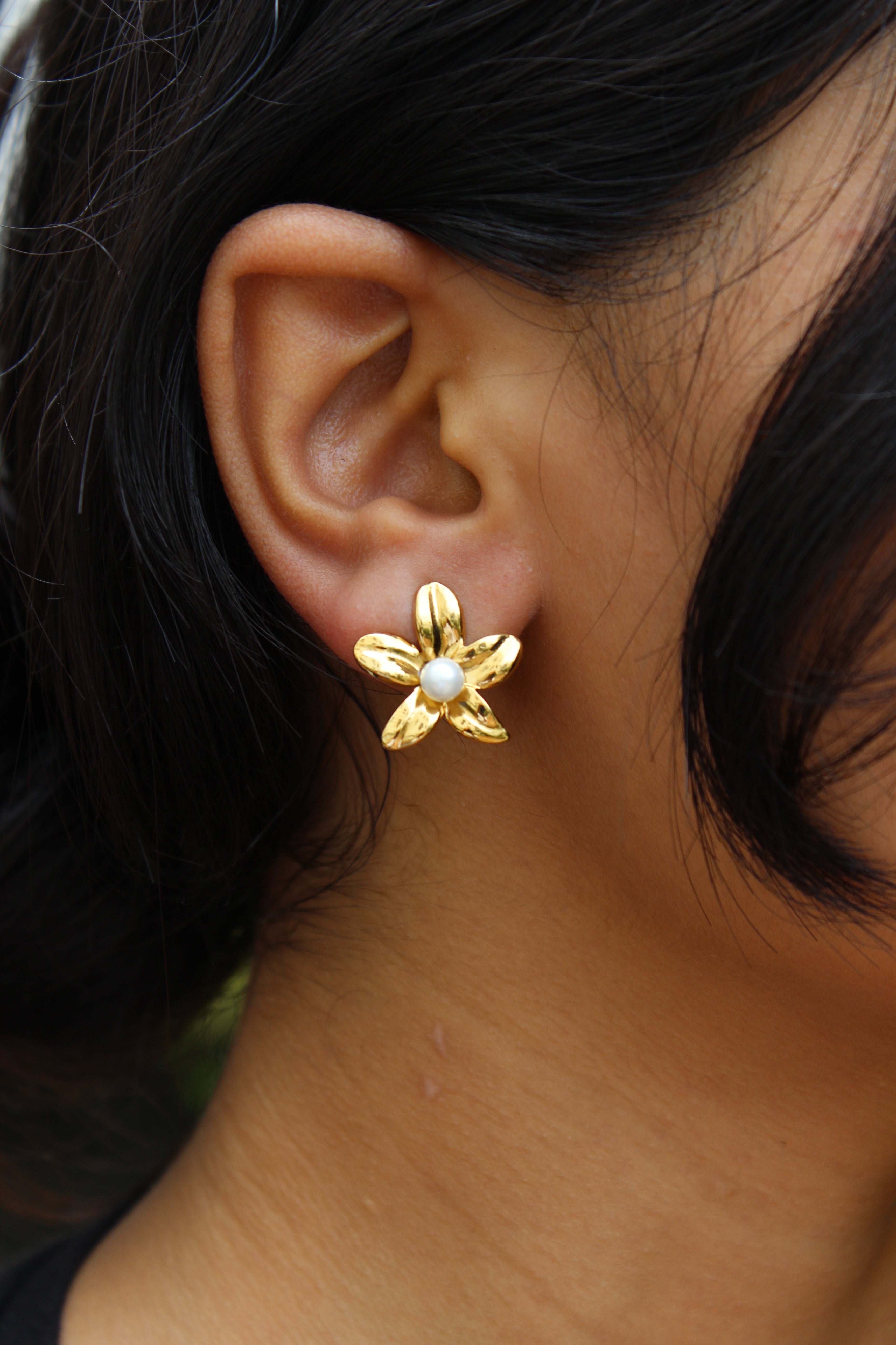 Golden Whisper Stud Earrings on model's ear