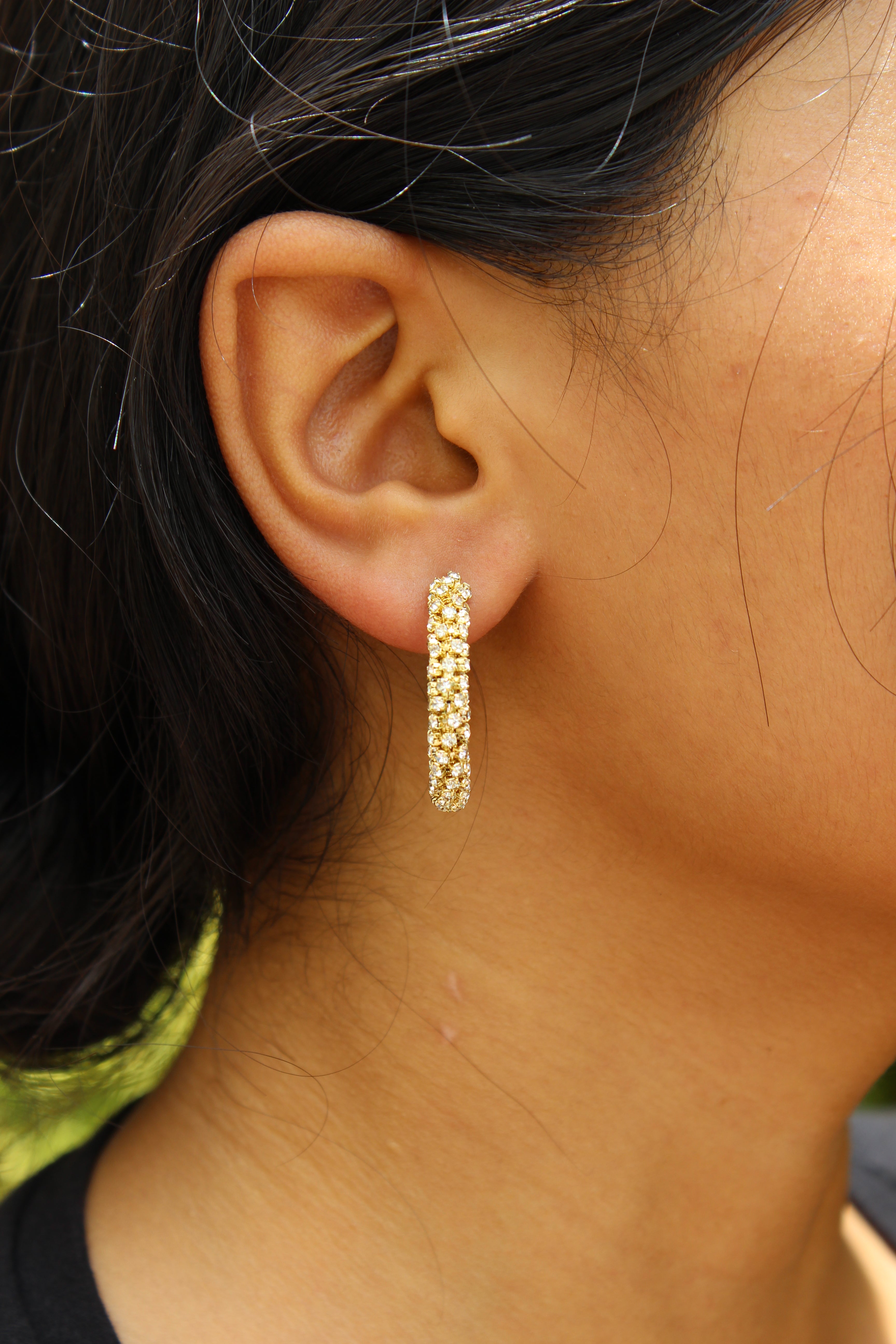 Lumira Hoop Earrings on model's ear with blurred background