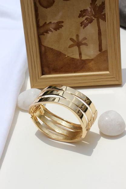Tide Warp Bracelet on a white surface with a wooden frame in the background