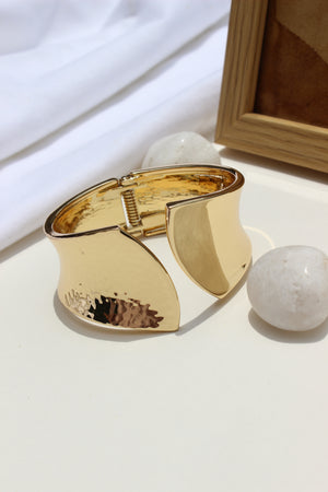 Sculpted Quiet Bracelet on a white surface with a blurred background