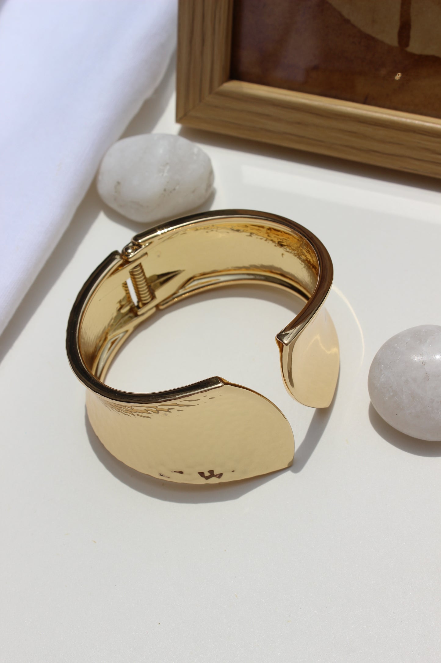 Sculpted Quiet Bracelet on a white surface with marble stones