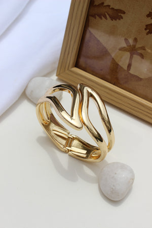 Heavy Petal Bracelet on a white surface with a blurred background