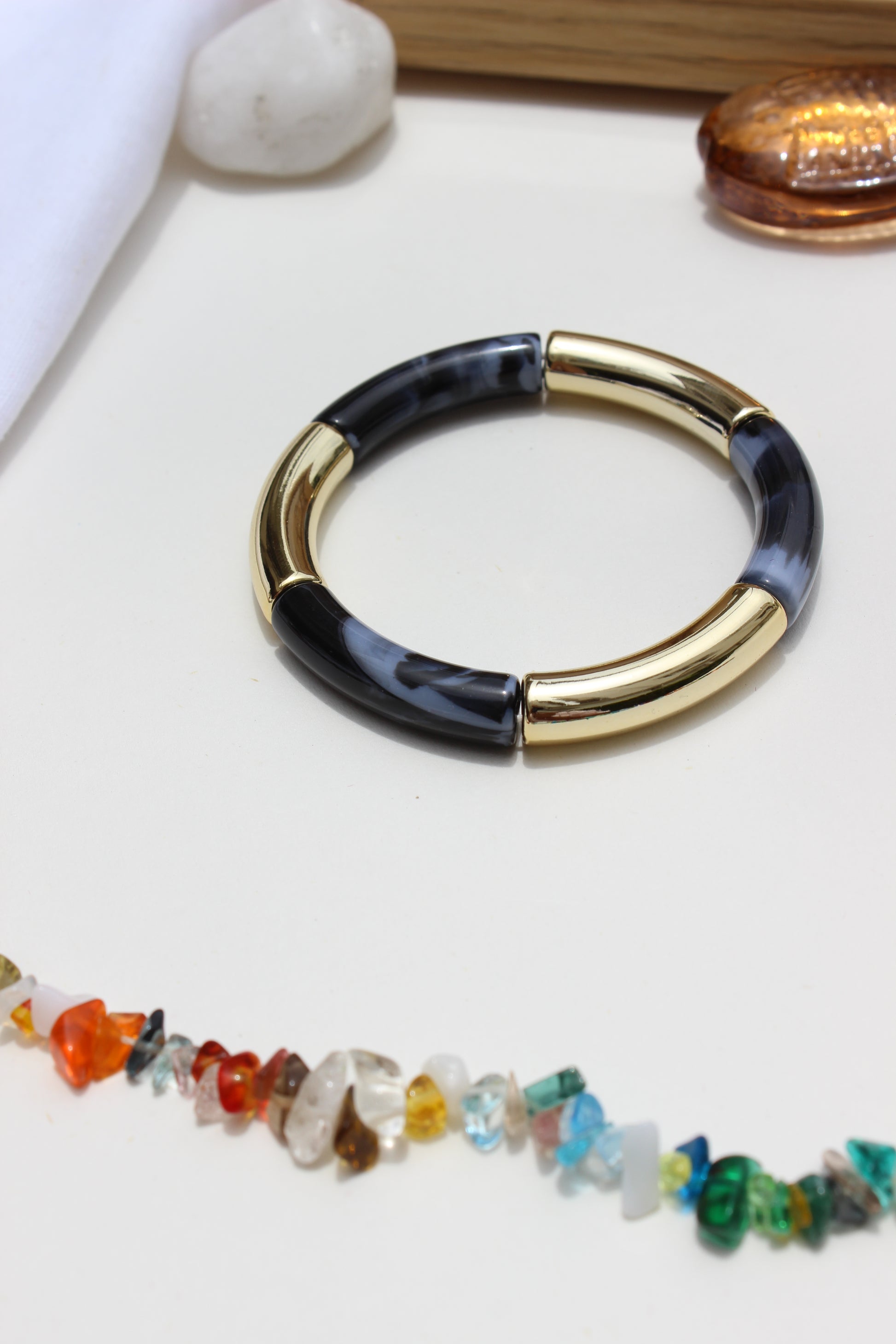 Mistplay Bangle Bracelets with black accent on a white surface