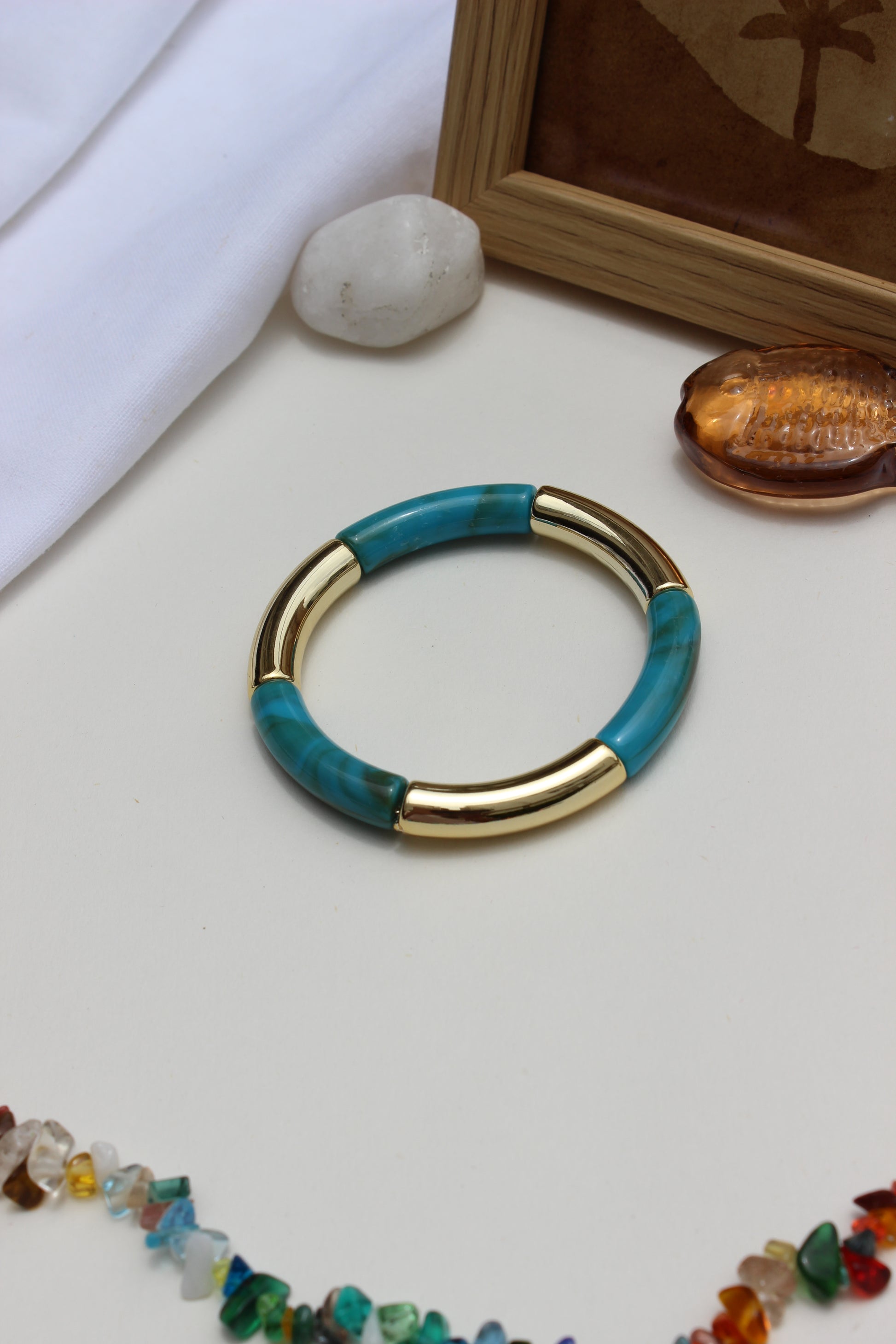 Mistplay Bangle Bracelets on a light surface with other jewelry items