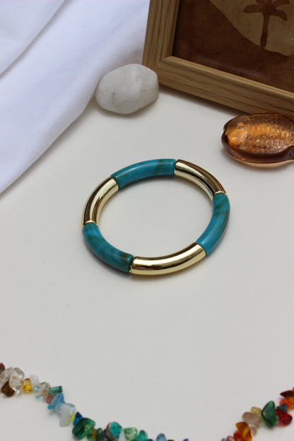 Mistplay Bangle Bracelets on a light surface with other jewelry items