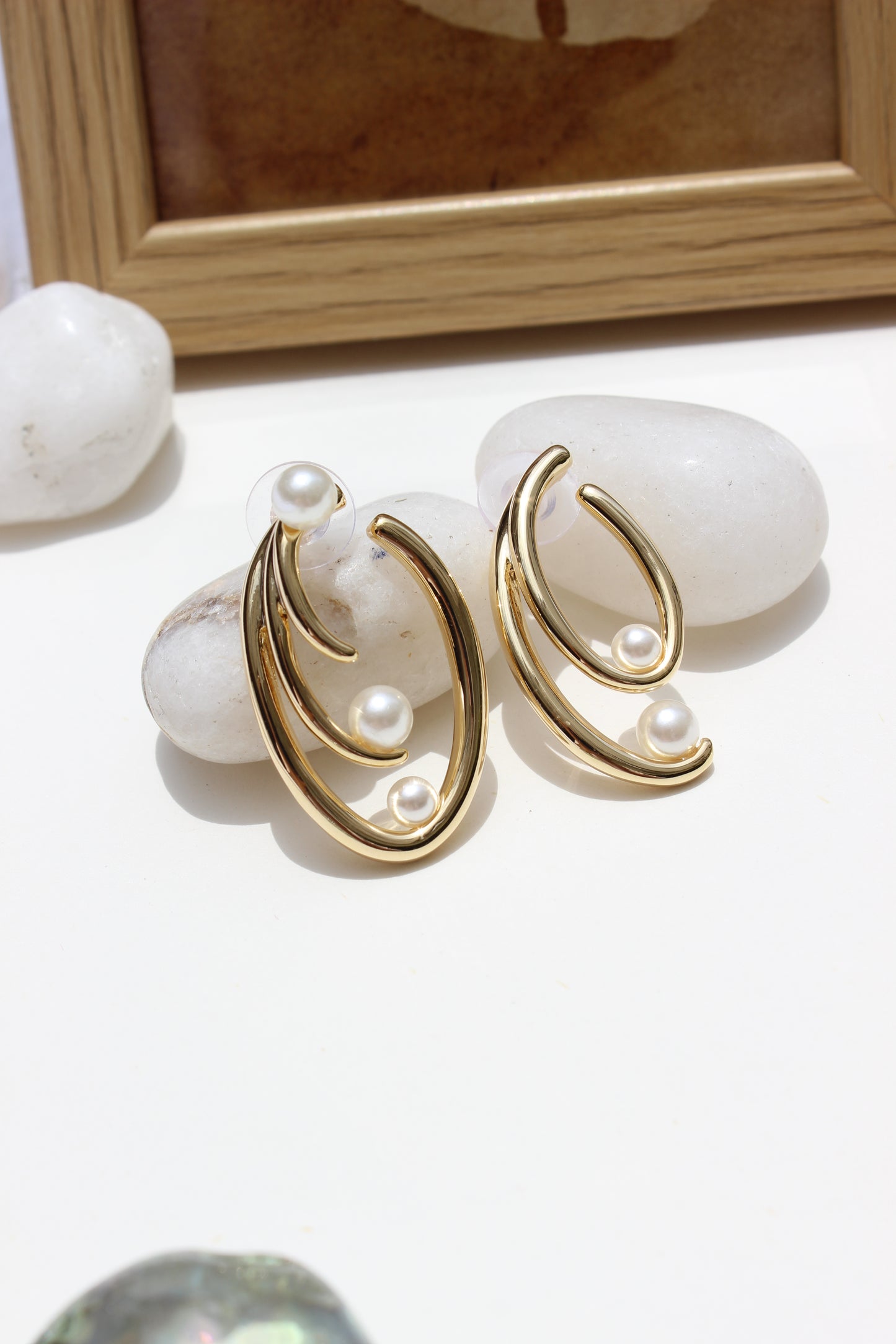 Not quite Twins Earrings on a white surface with a blurred background