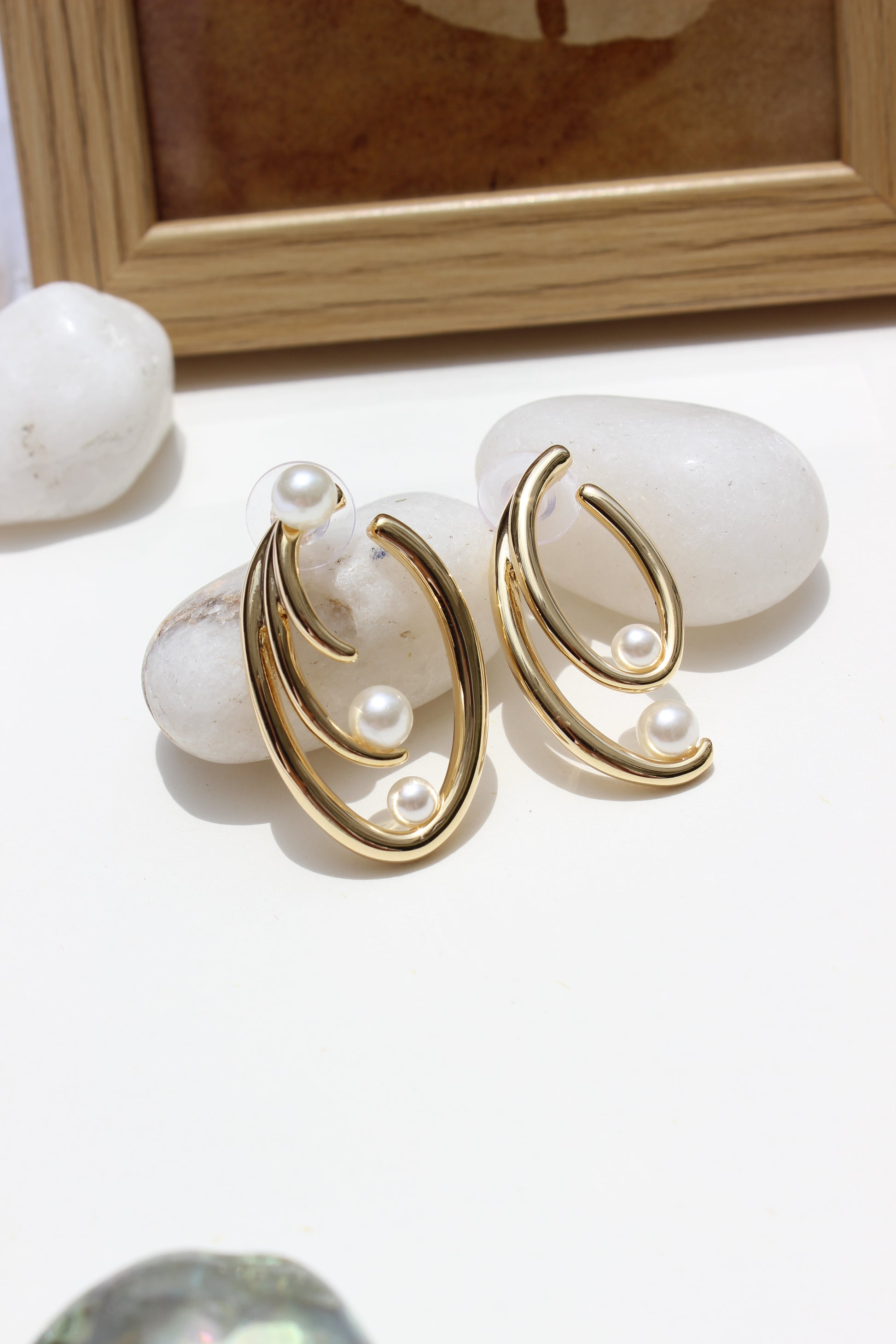 Not quite Twins Earrings on a white surface with a blurred background