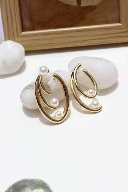 Not quite Twins Earrings on a white surface with a blurred background