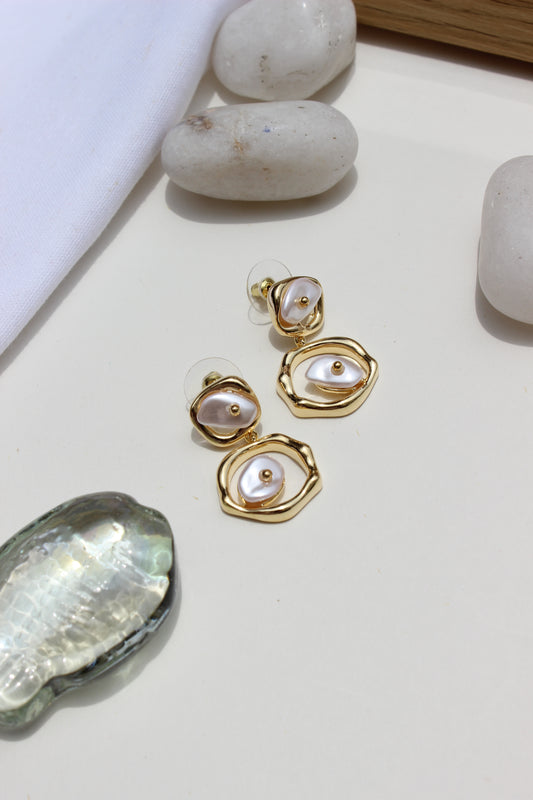 Sea of Silence Earrings with pearl-like stones on a light surface