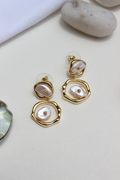 Sea of Silence Earrings with pearl-like stones on a light background