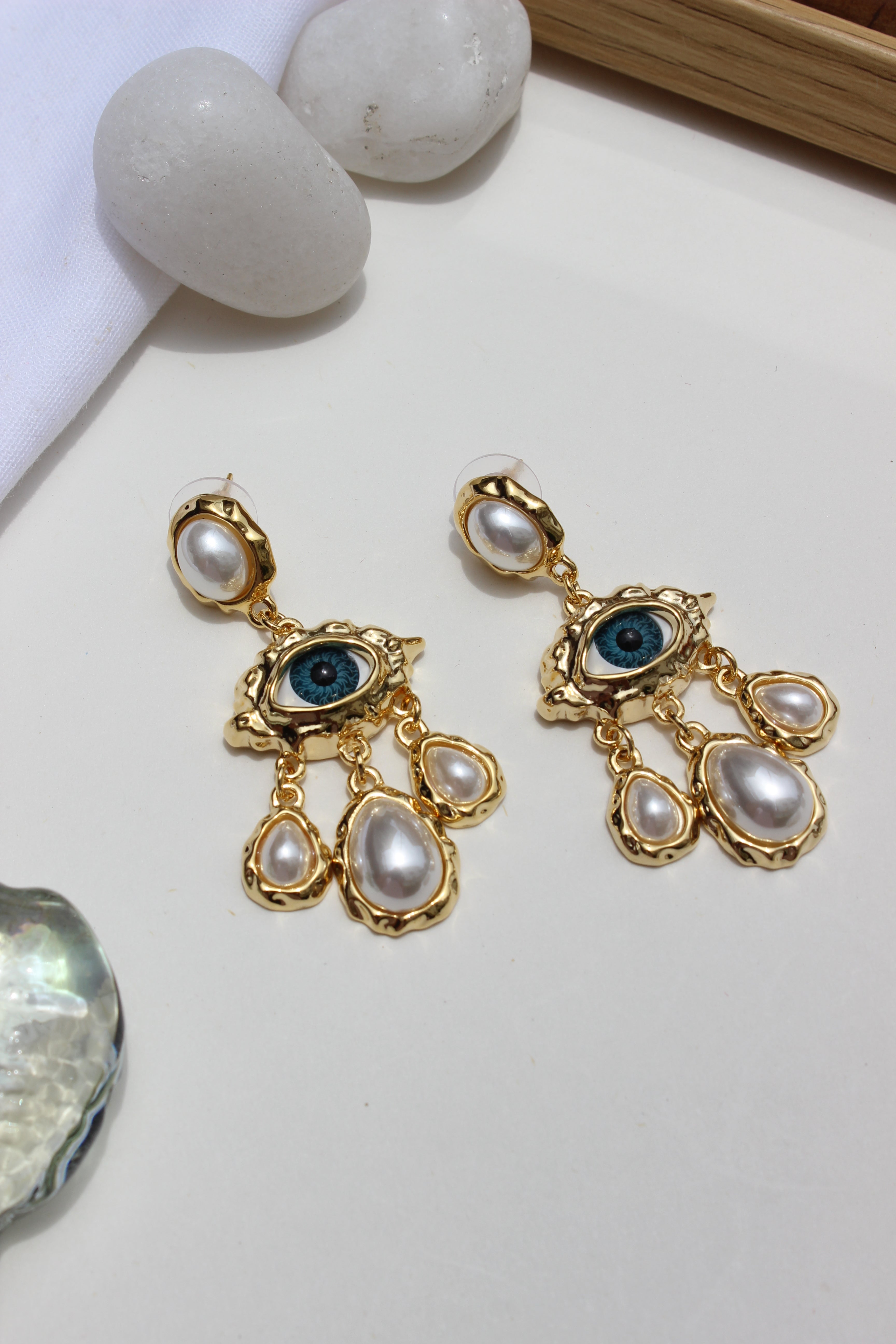 Born of Sea Earrings with pearl-like stones on a light background
