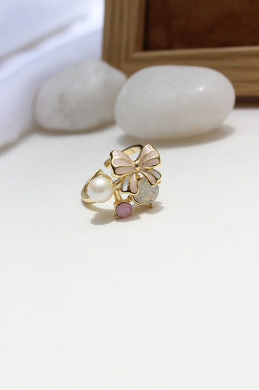 Saltbloom Ring with floral design and pearl on a white surface