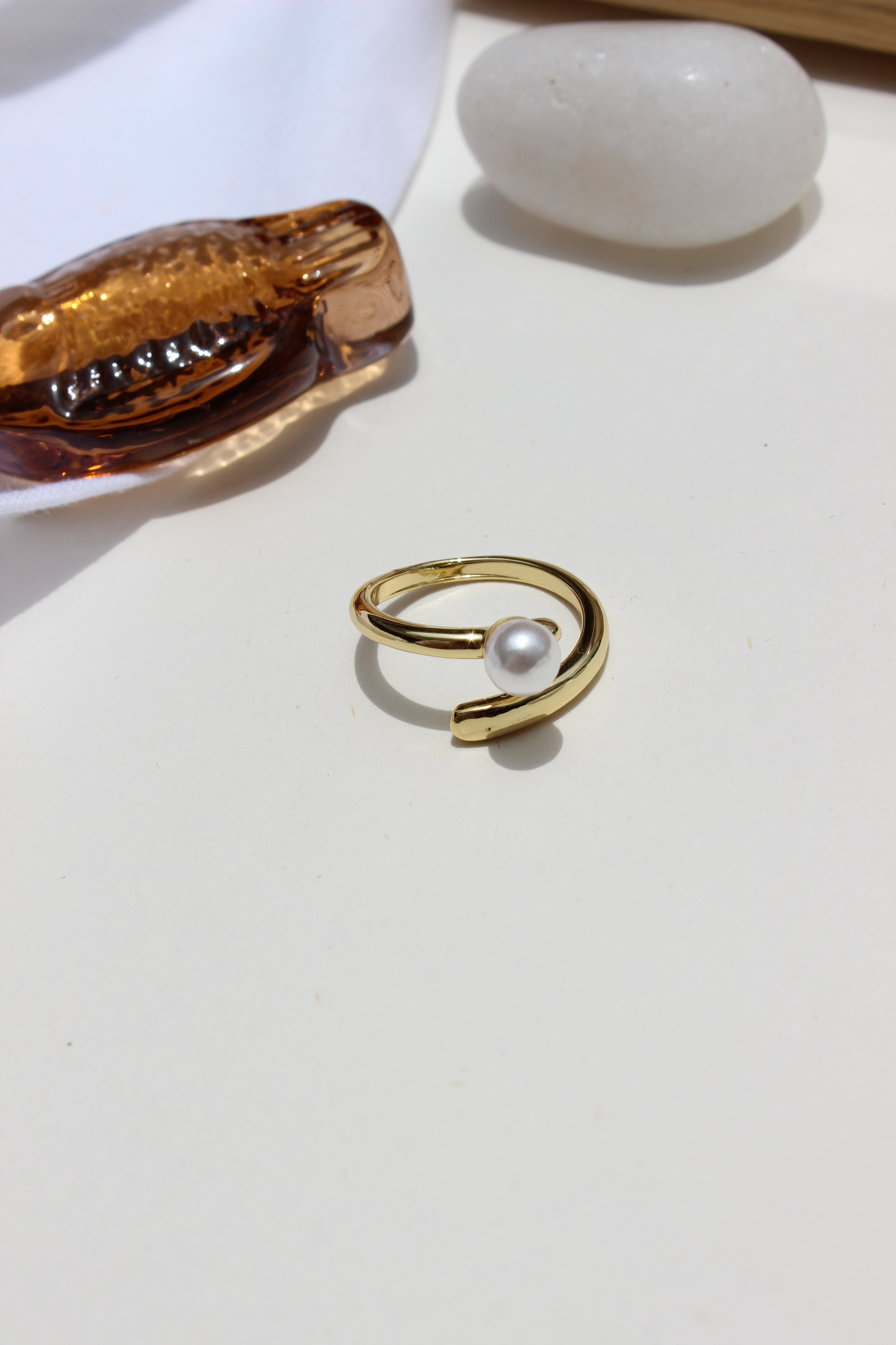 Folded Glow Ring with pearl on a white background