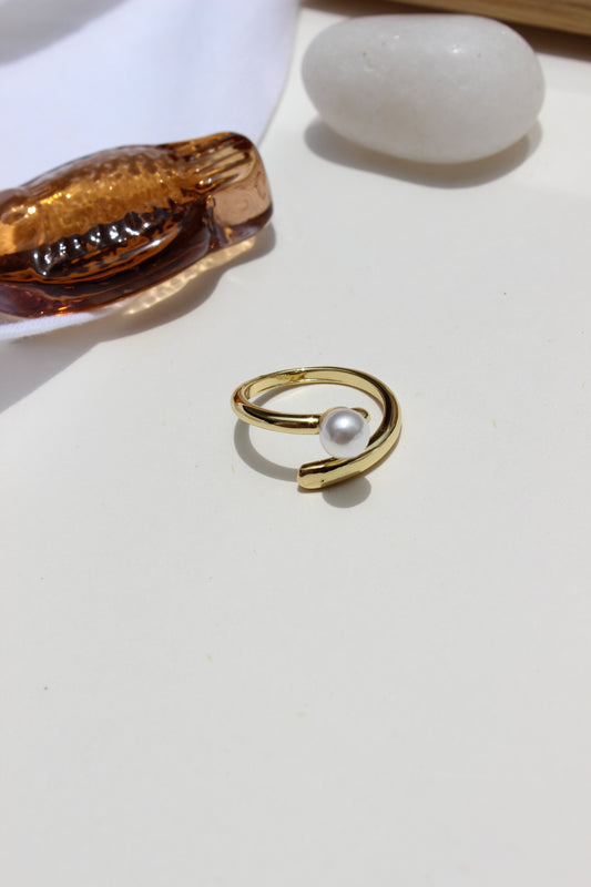 Folded Glow Ring with pearl on a white background