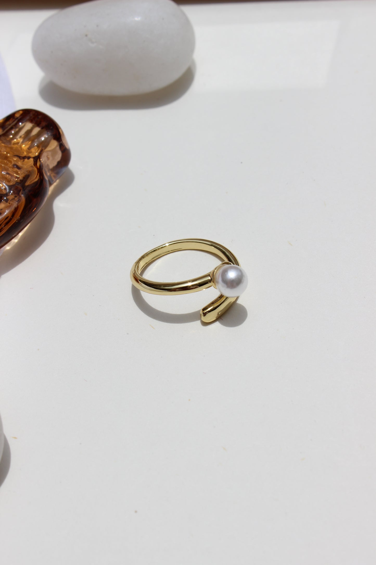 Folded Glow Ring with a seashell on a white background