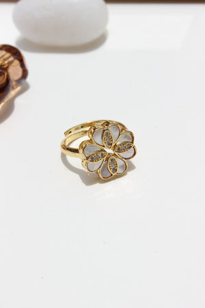 She of the Sea Ring with a floral design on a white background