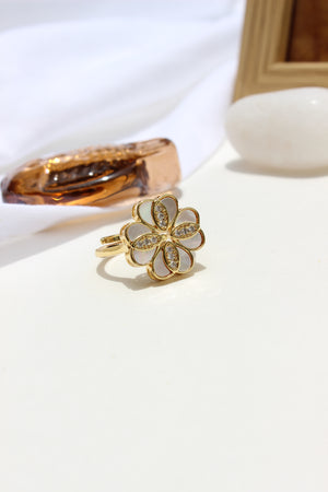 She of the Sea Ring with a clover-shaped design on a white background