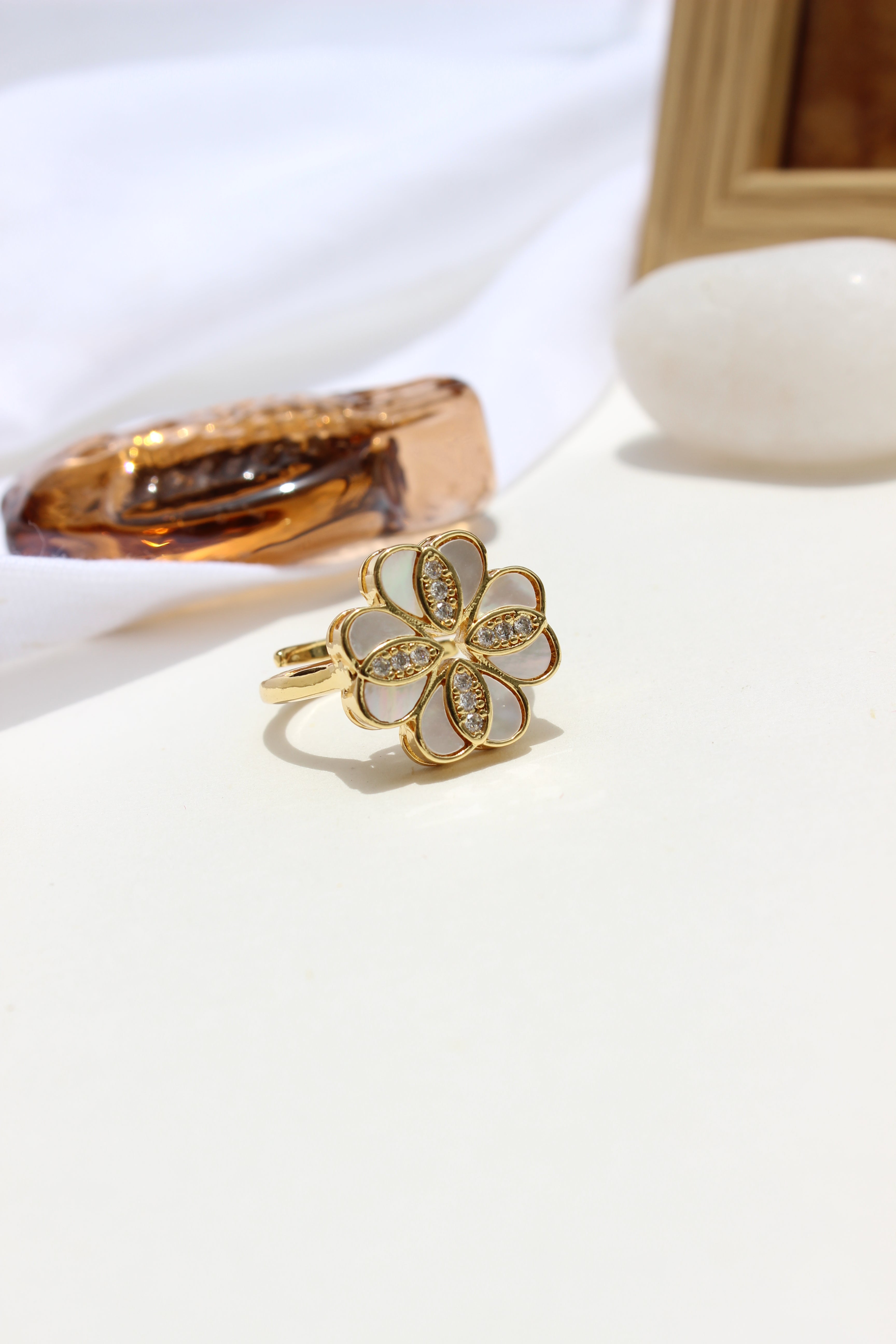 She of the Sea Ring with a clover-shaped design on a white background