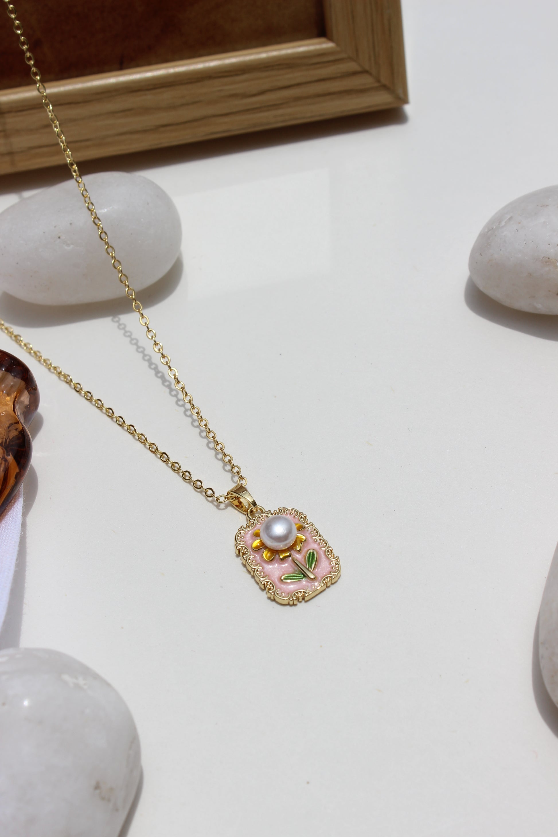 Petal of the Ocean Pendant Necklace with a pearl-like bead on a light background
