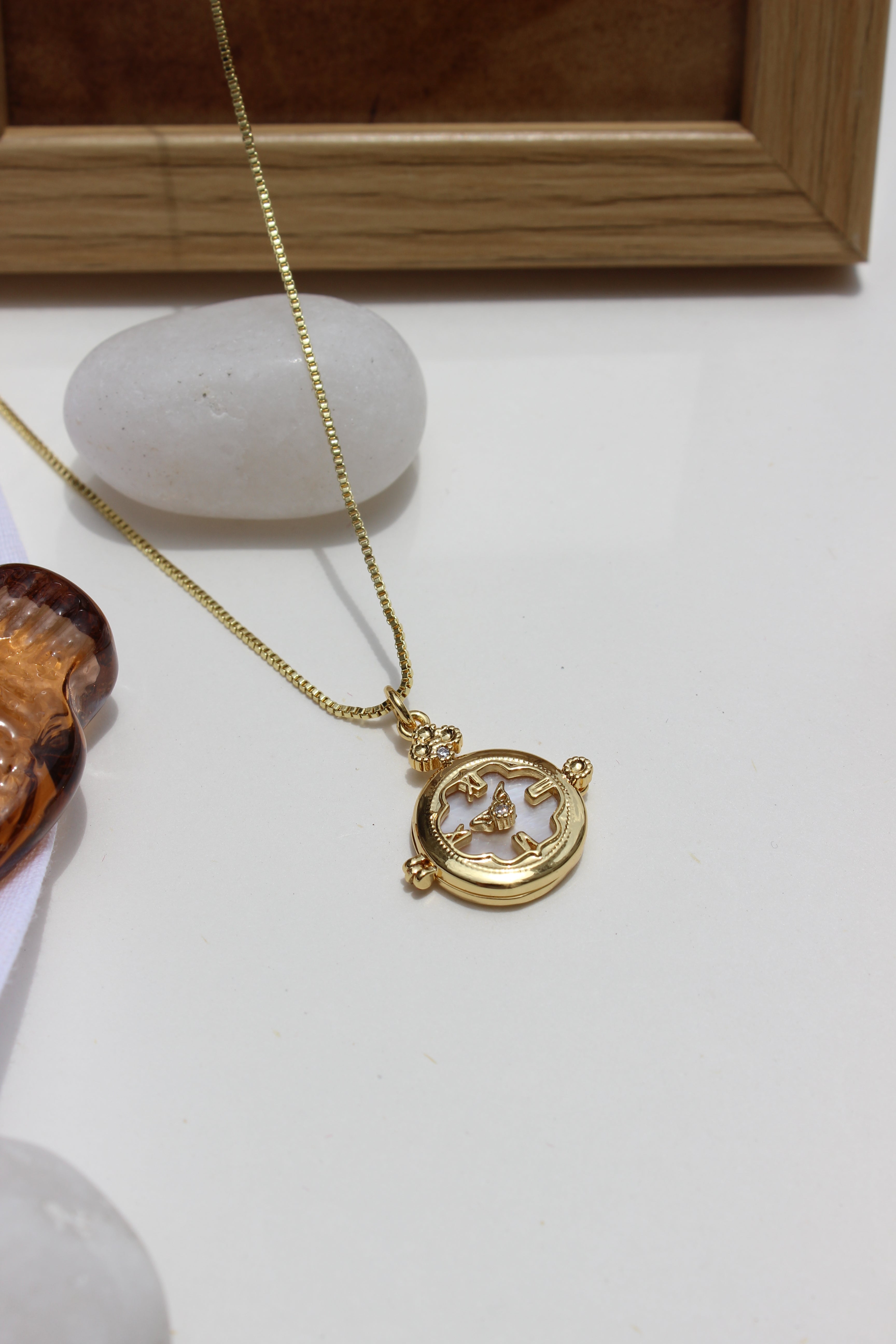 Whitespell Pendant Necklace on a white surface