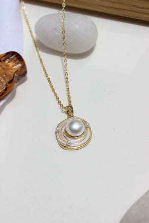 Bound in Pearl Pendant Necklace on a white surface