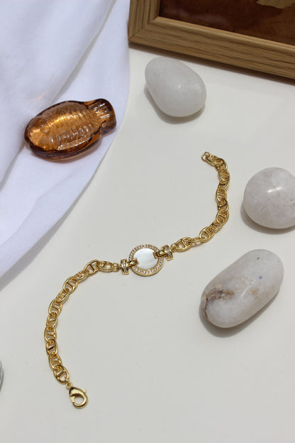 Sea of Light Bracelet on a white surface with stones and a wooden frame in the background