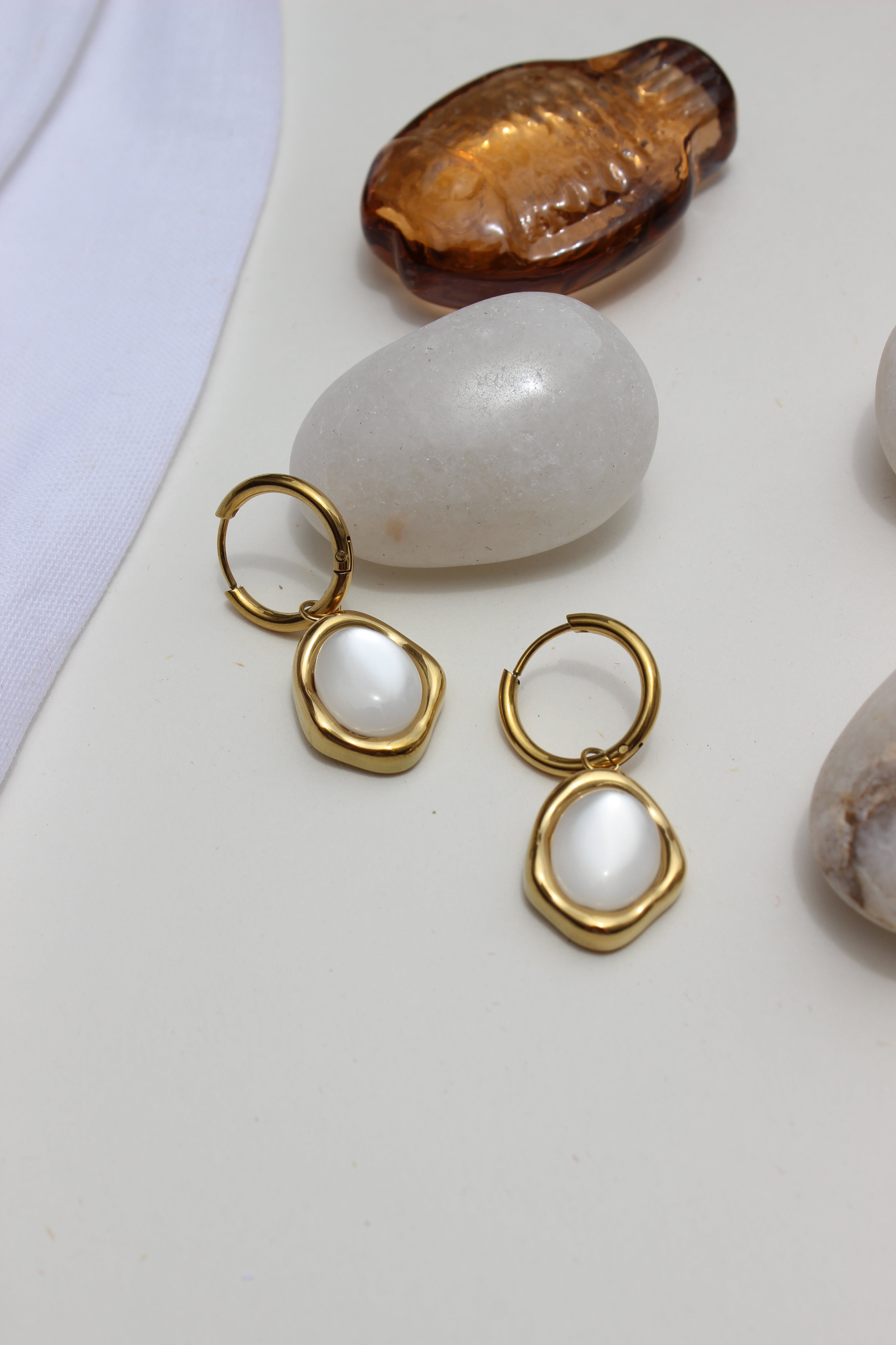 Stillwater Pearl Hoop Earrings with pearls on a white surface