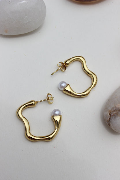 Pearl Fold Half Hoop Earrings on a light background
