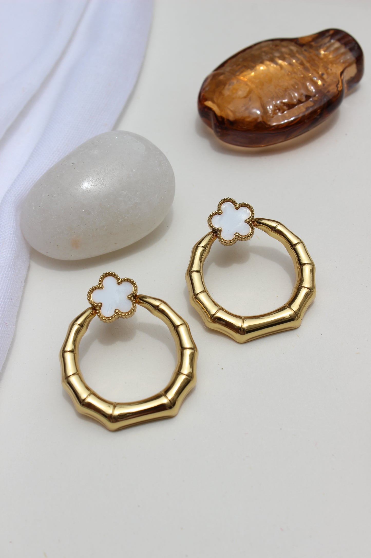 Moon Blossom Earrings with floral designs on a white surface