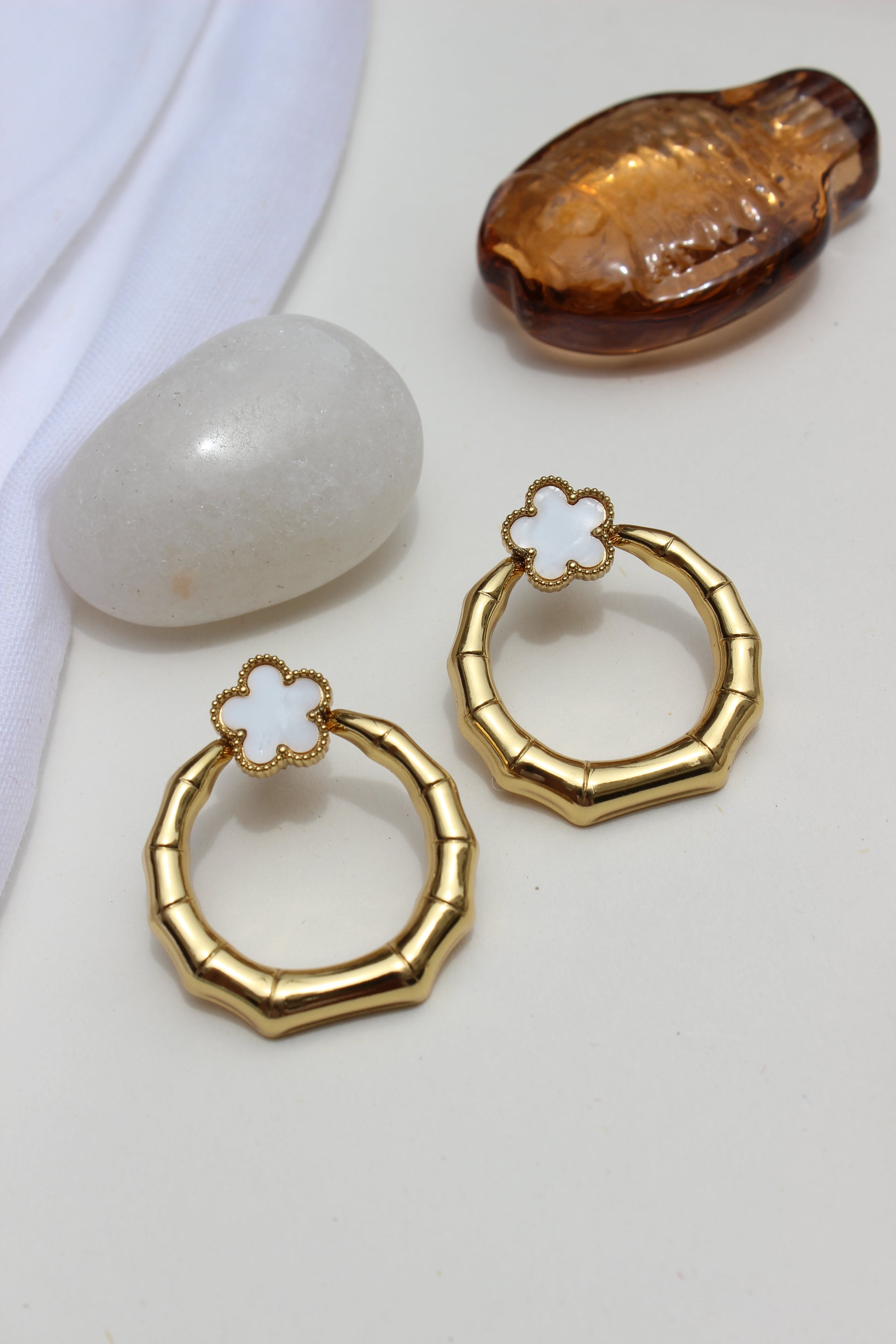 Moon Blossom Earrings with floral designs on a white surface