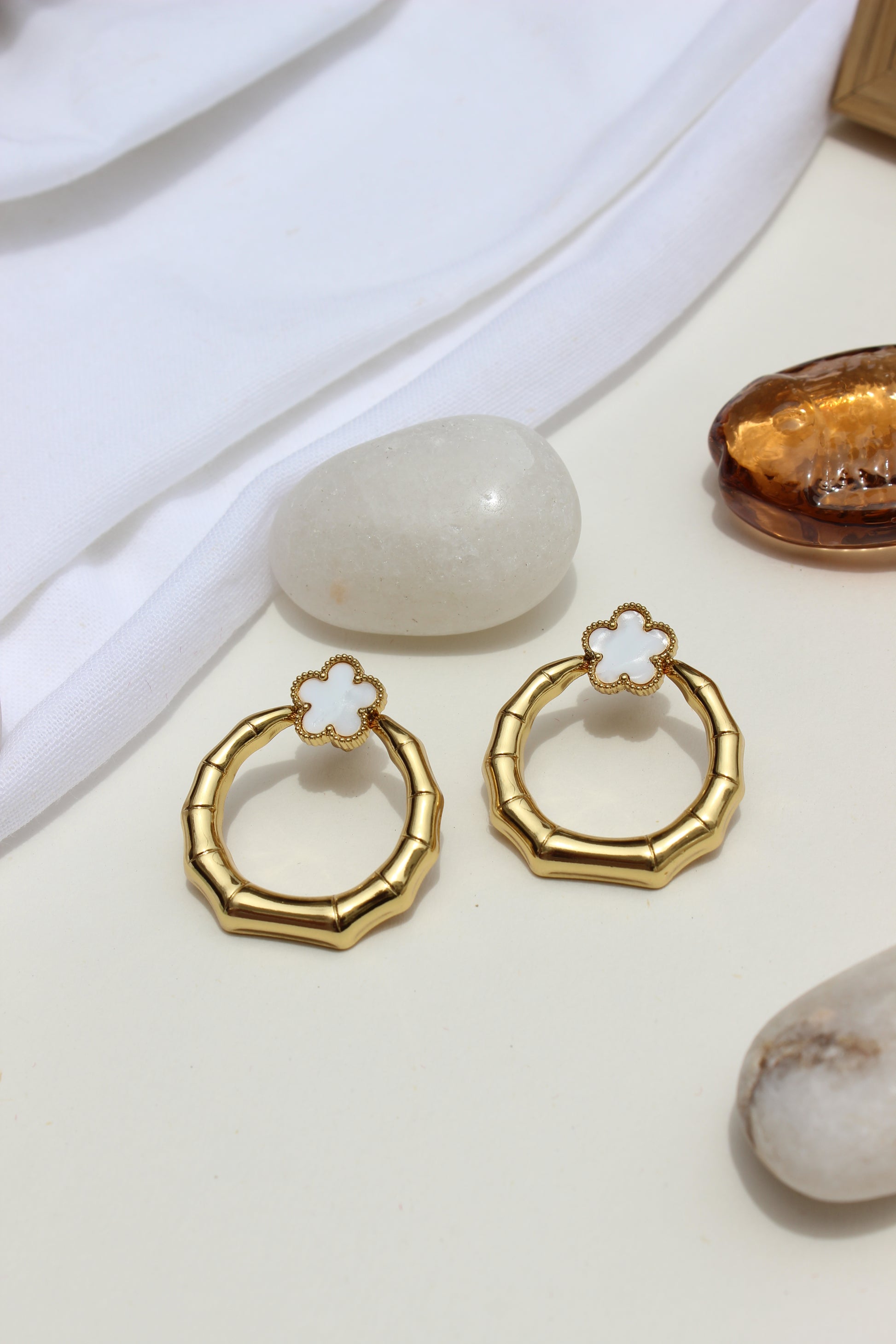 Moon Blossom Earrings with floral details on a neutral background