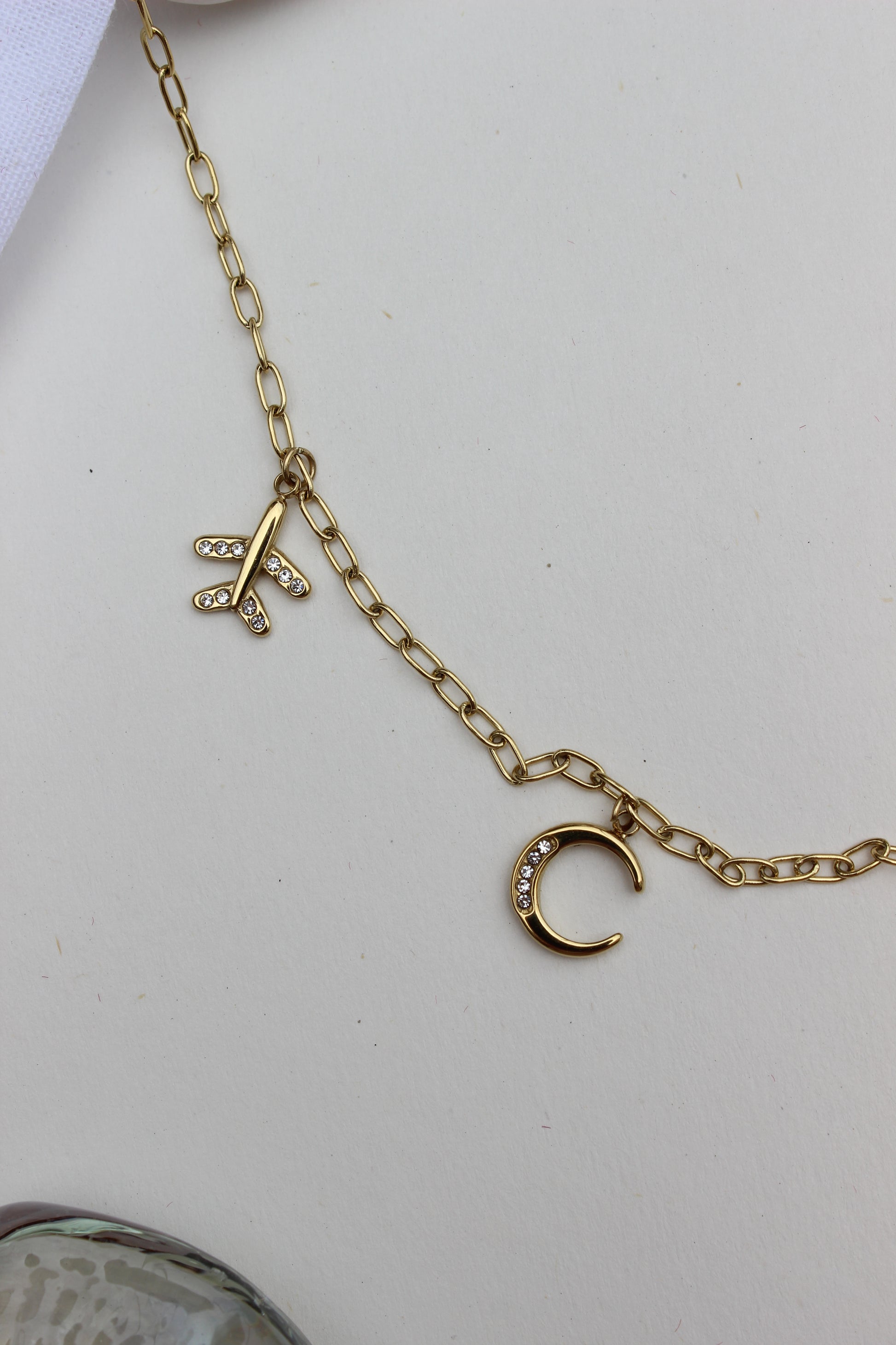 Where She Wanders Charm Necklace on a light gray background