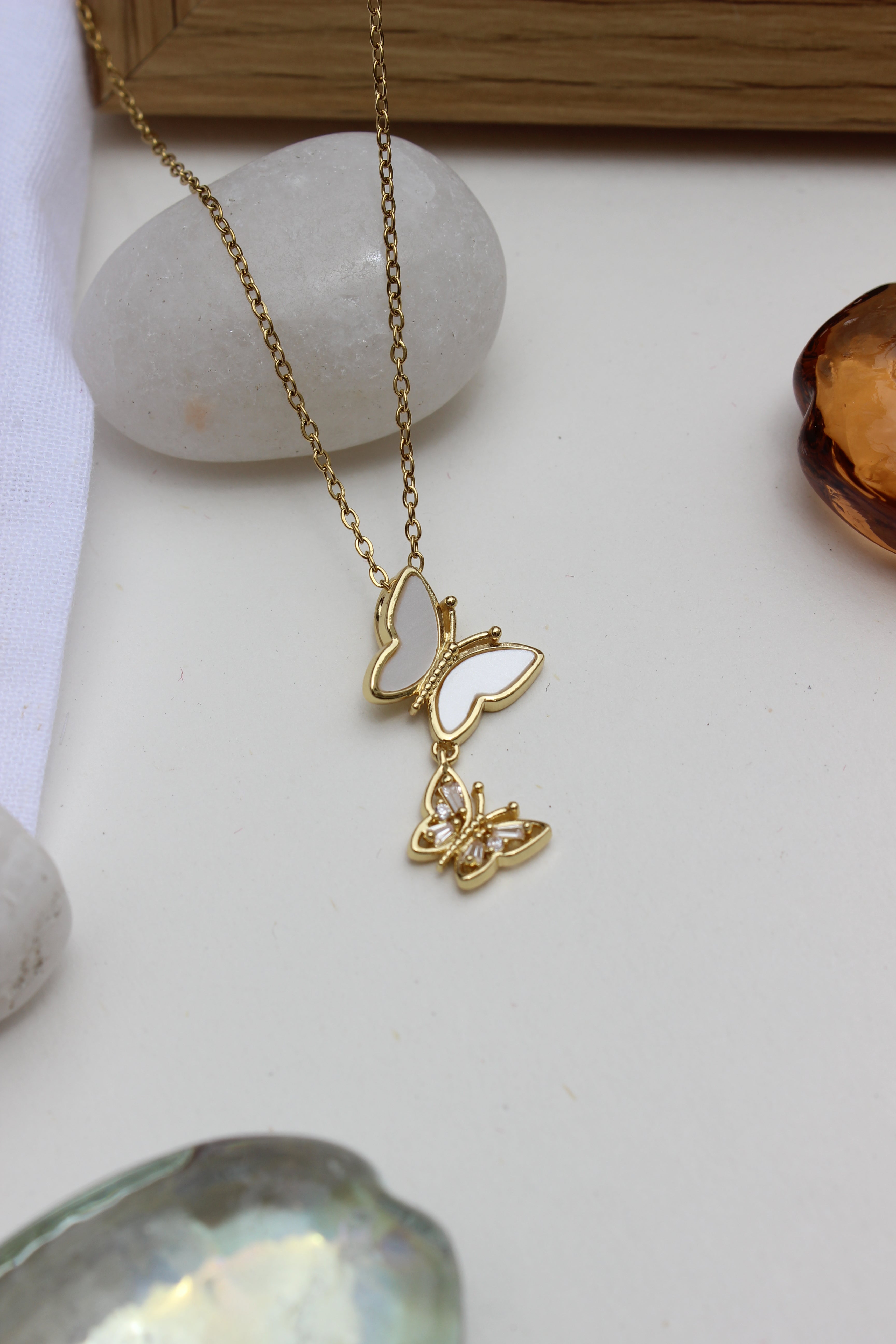 Clarisee Pendant Necklace on a white surface with a neutral background