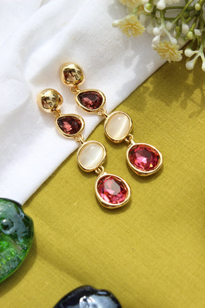 Ocean Glows Pink Earrings on a white and green fabric background