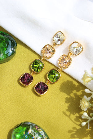 Moonkiss Drop Earrings on a yellow fabric background with flowers