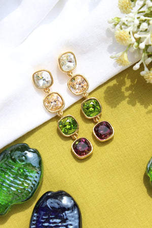 Moonkiss Drop Earring on yellow and white fabric background