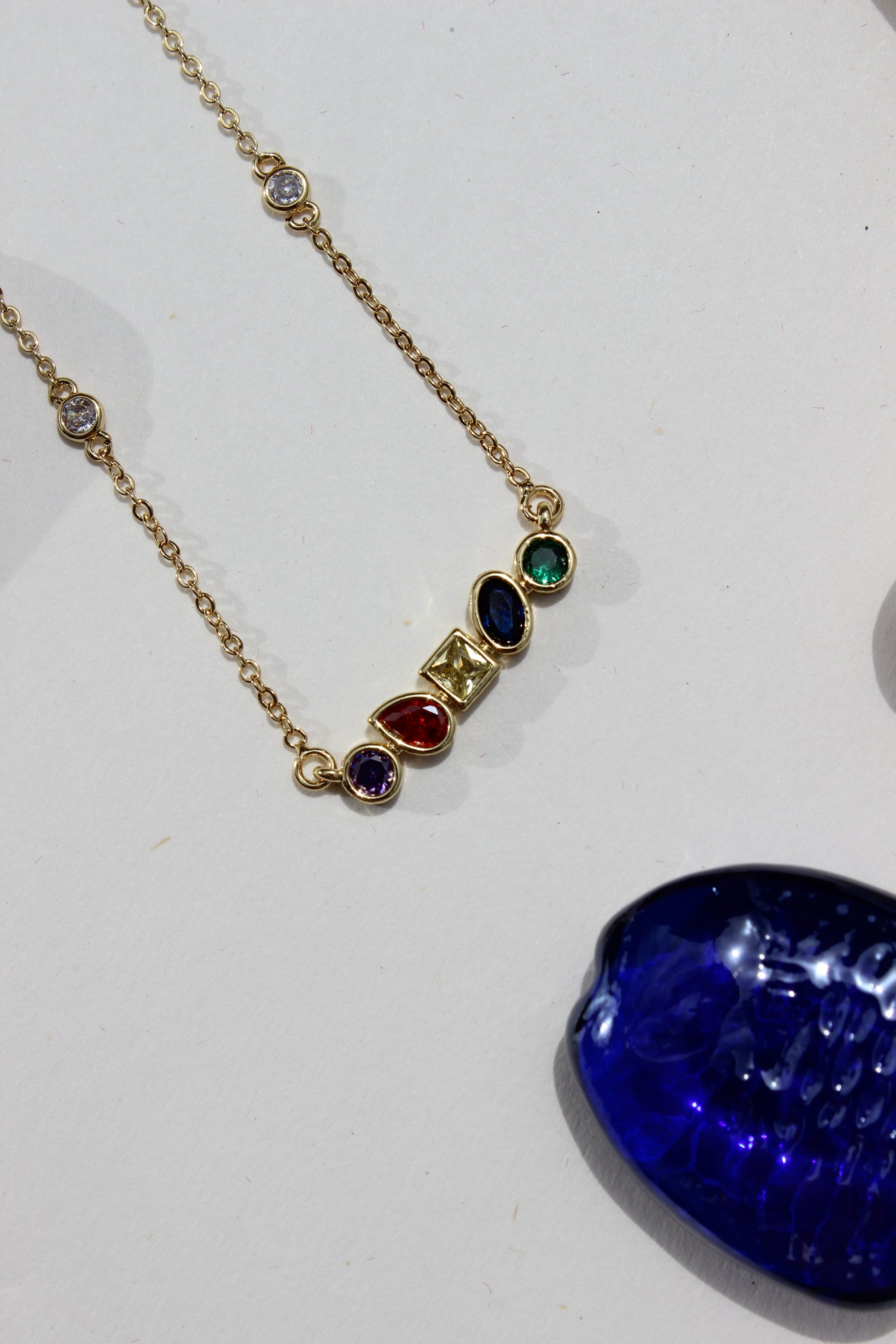 Carry Light Pendant Necklace on a white surface nearby seashell