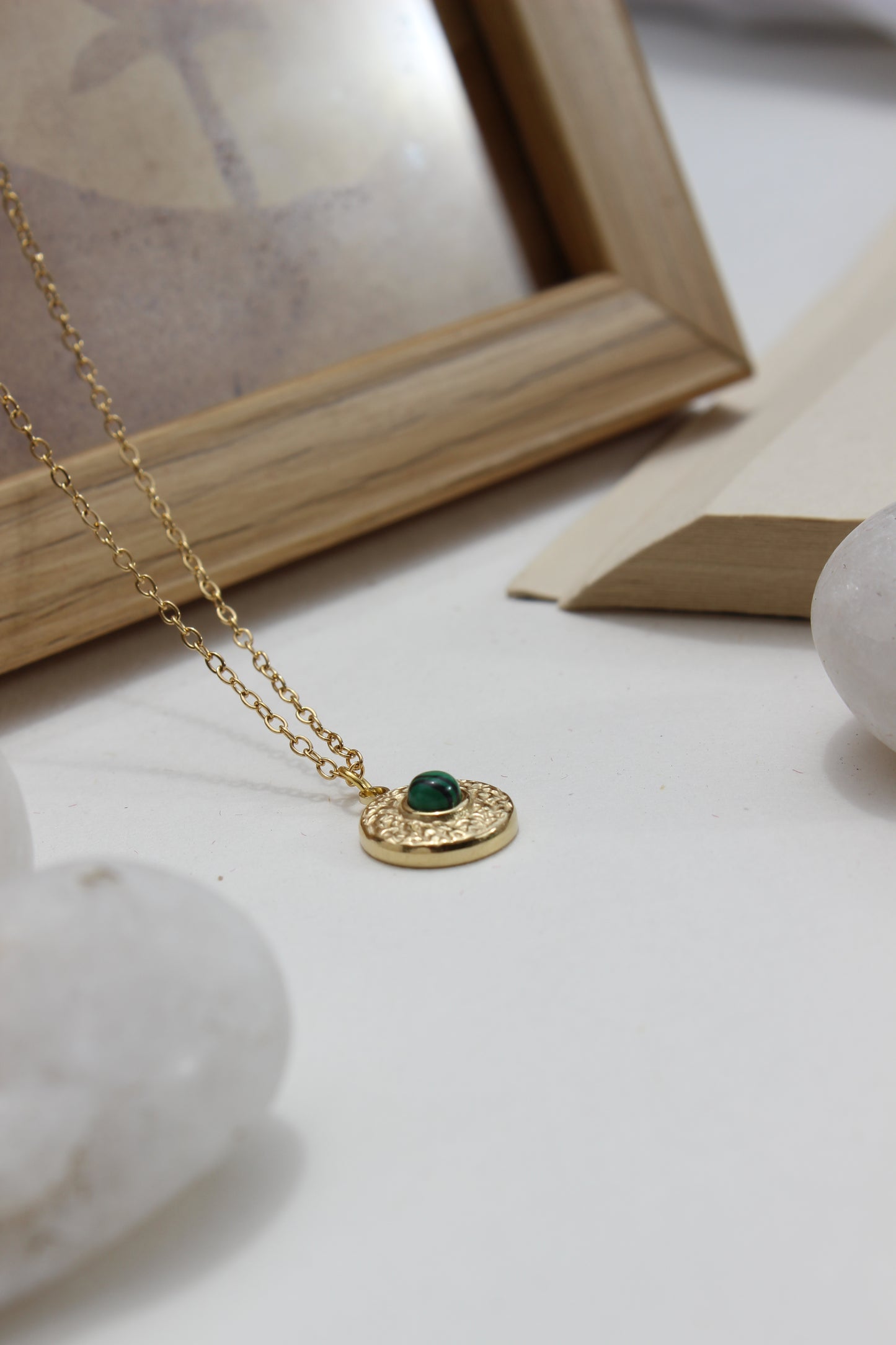 Forest Pulse Pendant Necklace on a marble surface