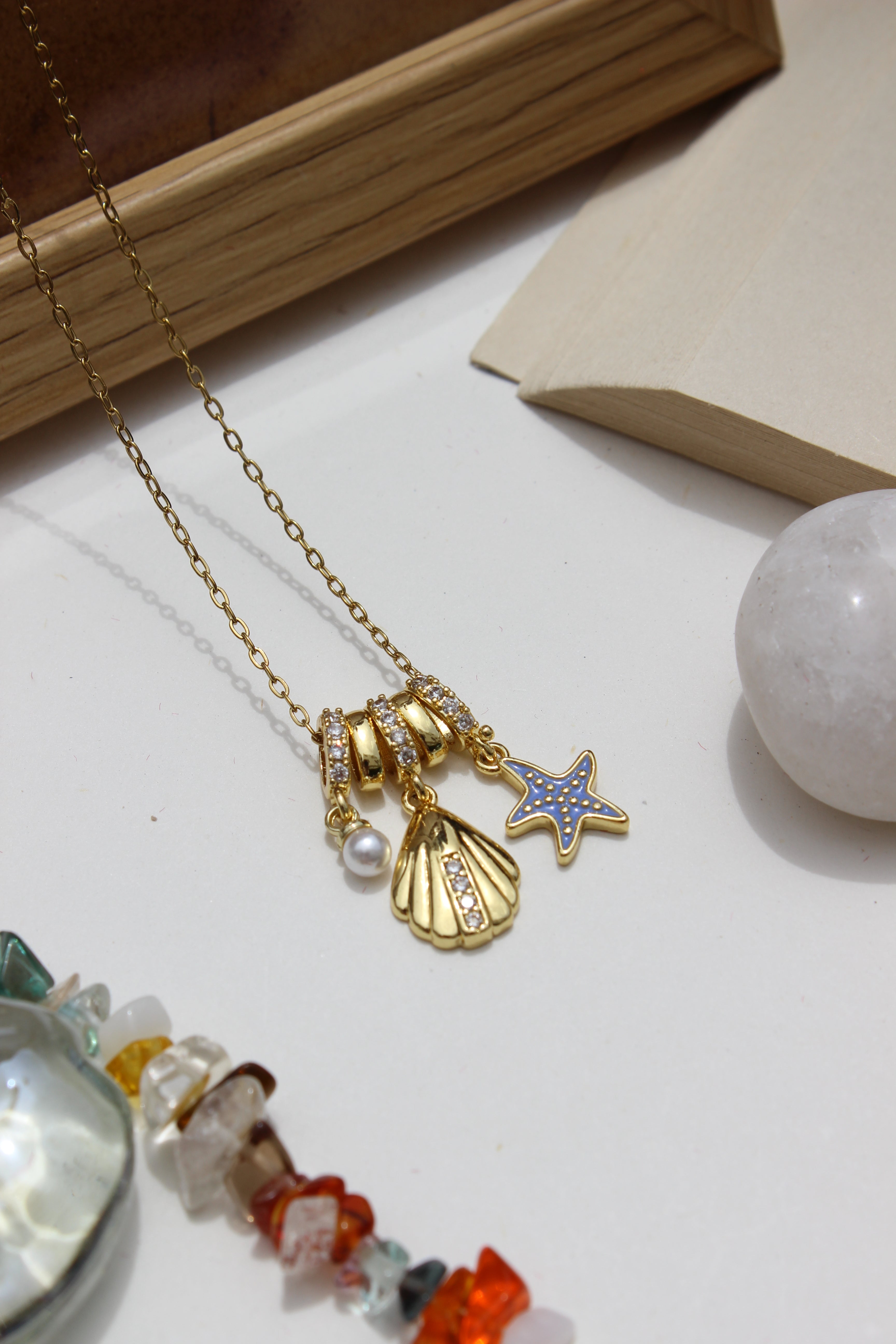 Mermaid Keepsake Charms Pendant Necklace on a white surface with crystals