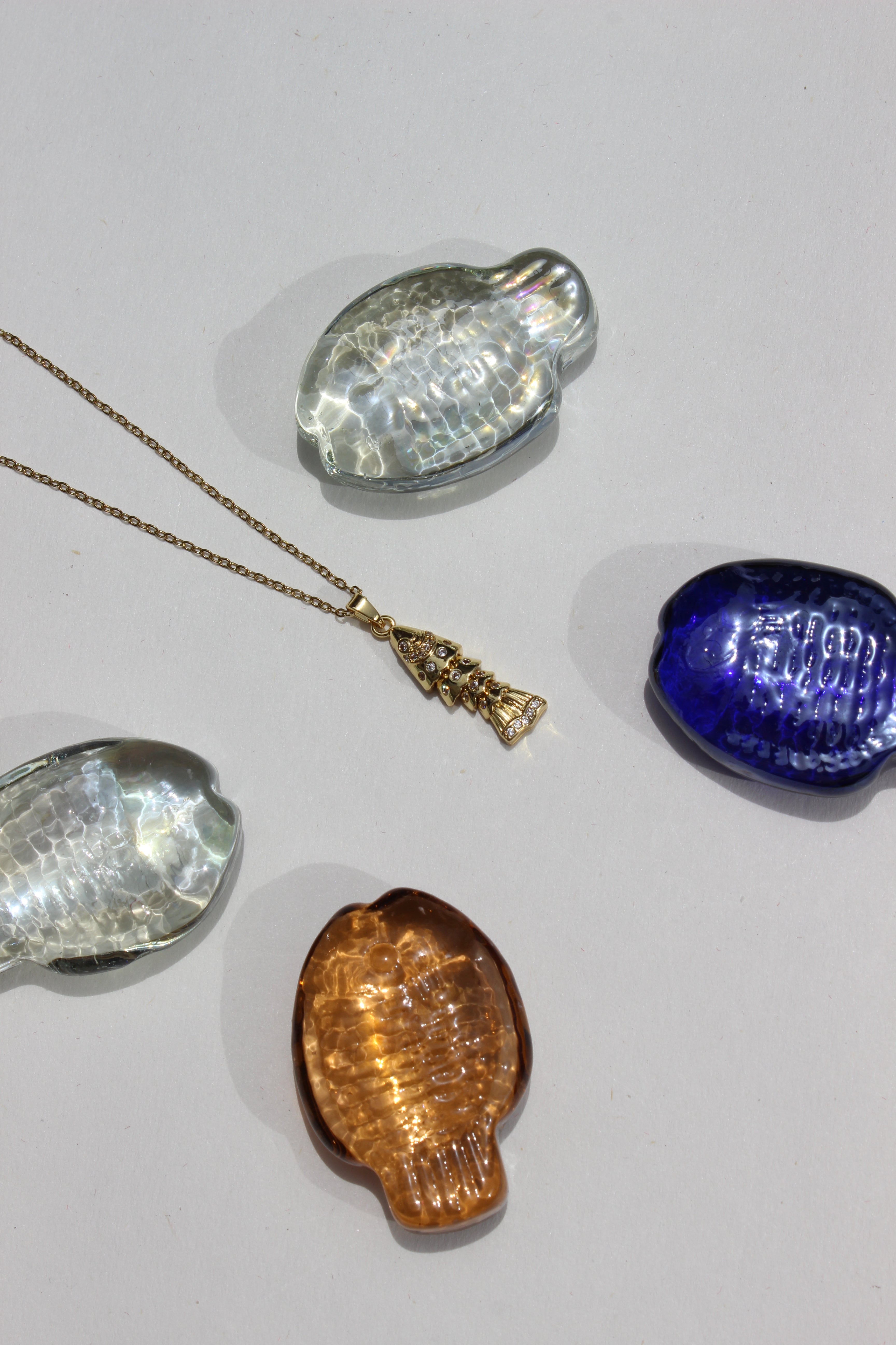 Ripple Tail Pendant Necklace on a gray background