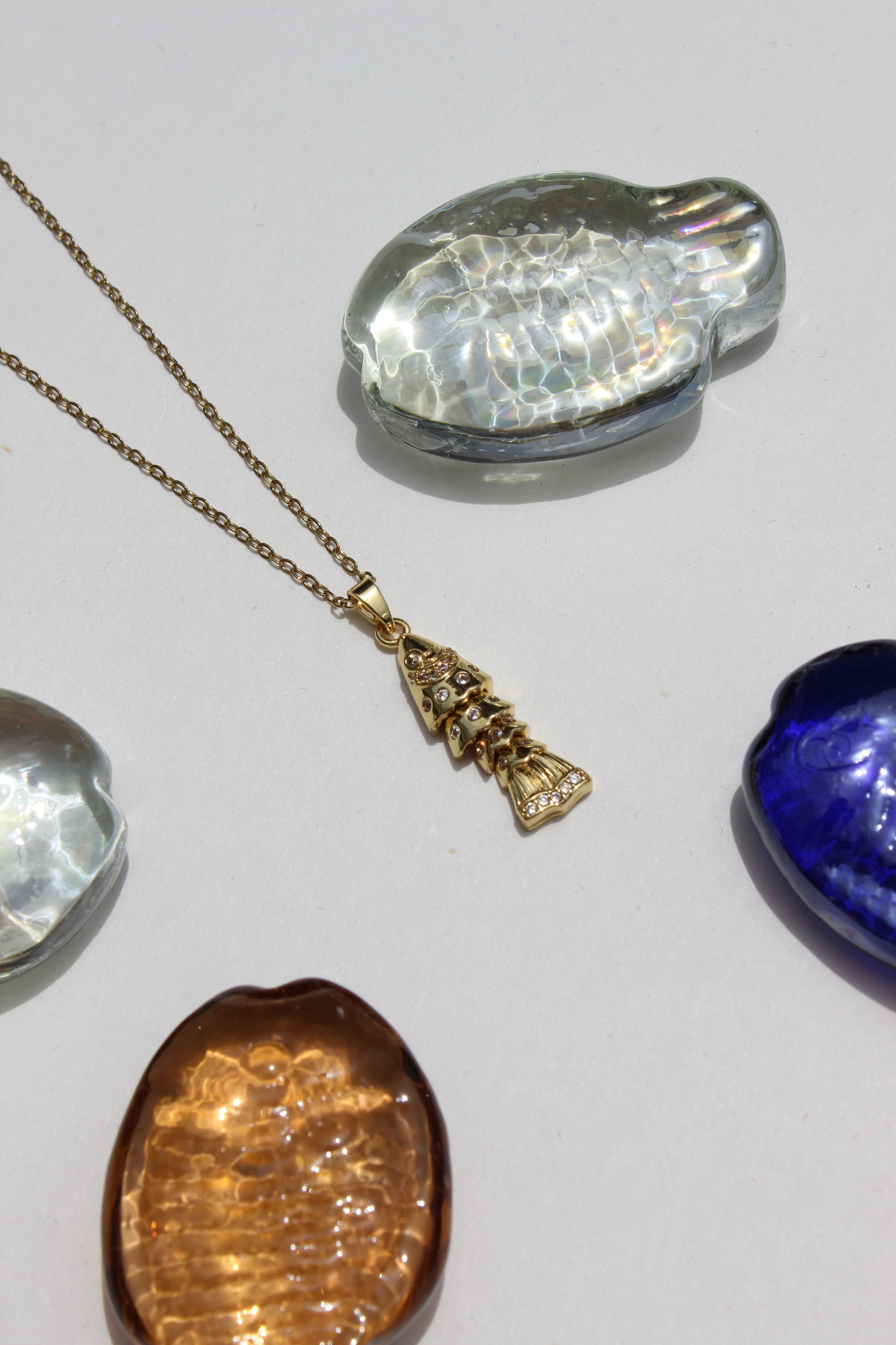 Ripple Tail Pendant Necklace on a light gray background