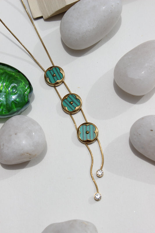 Green Mirage Necklace on a white surface with stones