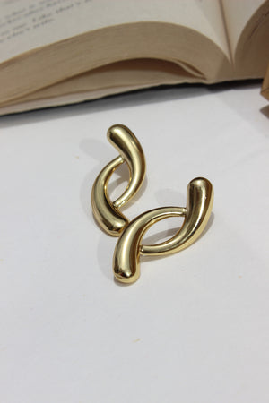 Lushline Earrings on a white surface with a blurred background