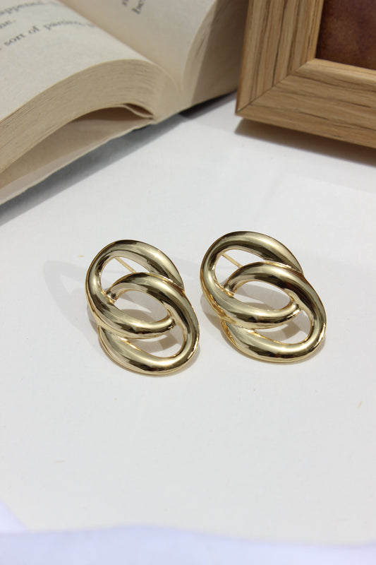 Daily Gleam Earrings on a white surface with a blurred background