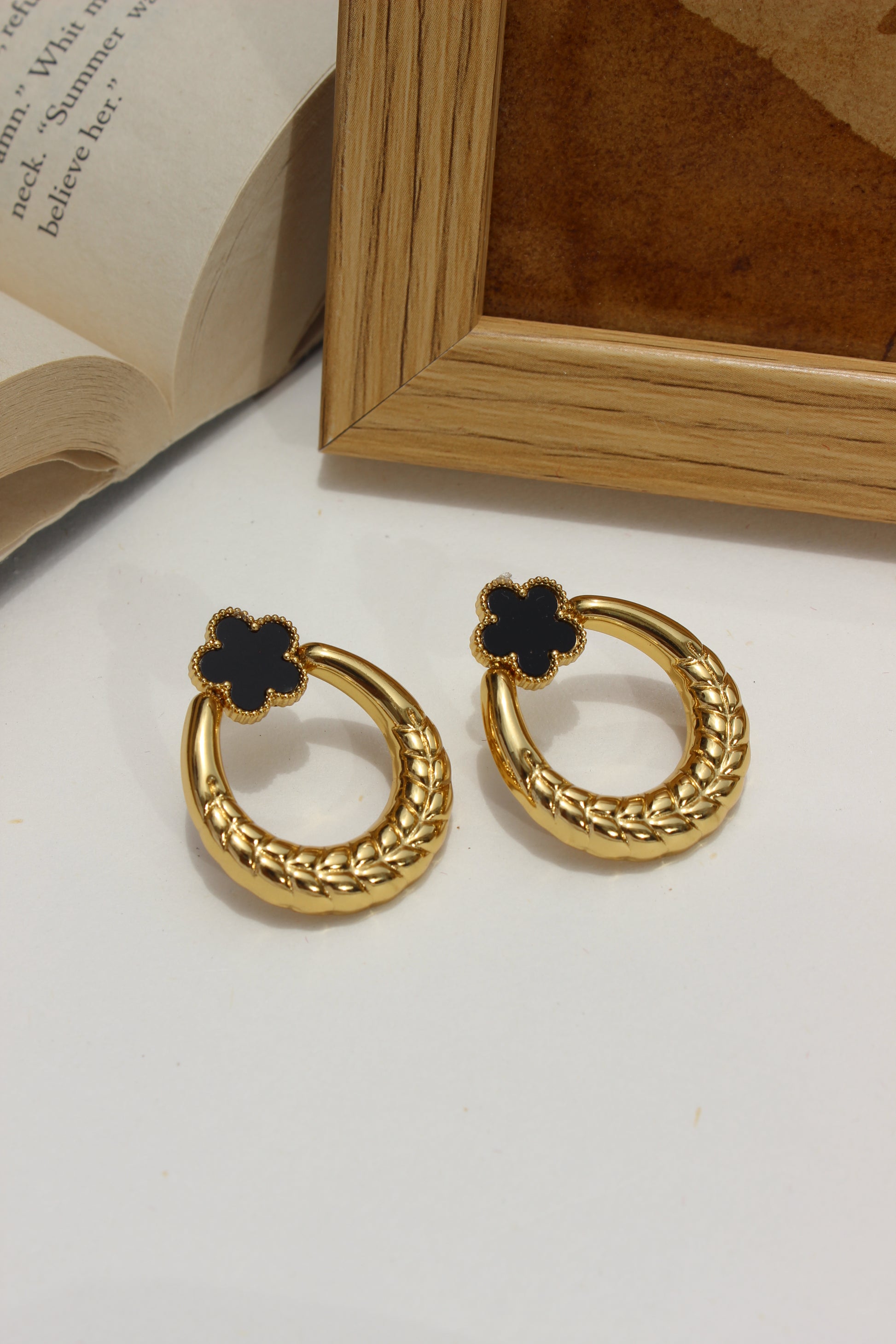 Orbella Earrings on a white surface